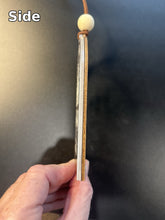 Load image into Gallery viewer, Side view of the ornament showing the acrylic and walnut layers, 1/4 inch thick